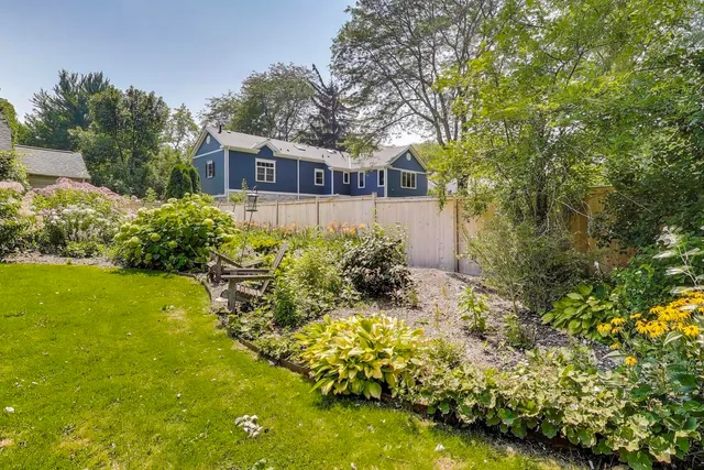 a front view of house with yard and green space