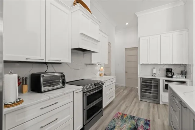 a kitchen with stainless steel appliances granite countertop a stove a sink and a refrigerator