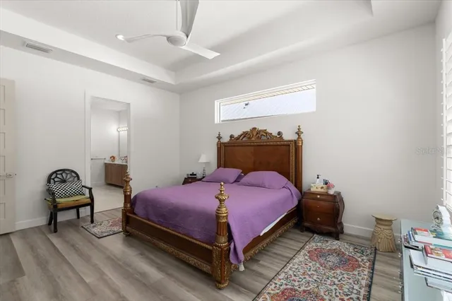 a bed room with a bed and a chair