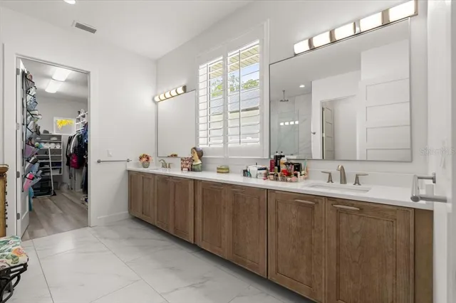 a bathroom with a granite countertop shower and a sink