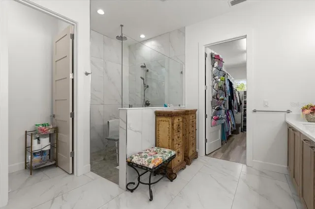 a view of walk in closet with clothes