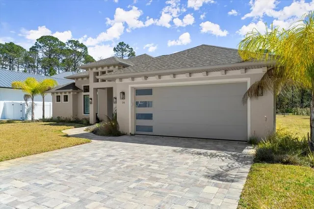a view of a house with a backyard and a tree