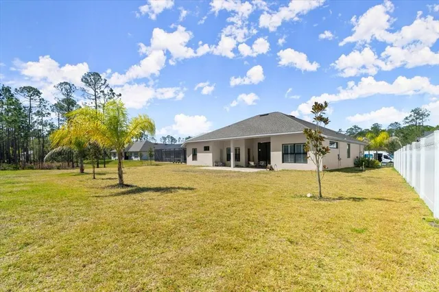 a aerial view of a house with a yard