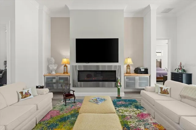 a living room with furniture a flat screen tv and a fireplace