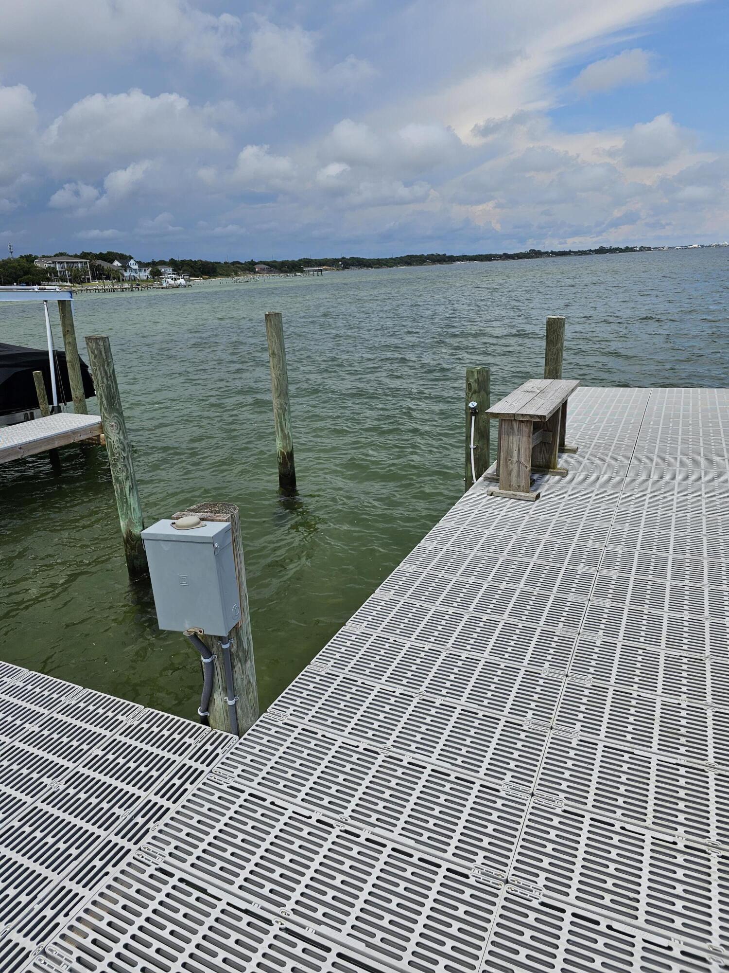 9389 Palmetto Ridge Court Navarre, FL 32566 - Photo 19 of 33 a view of a terrace with a bench