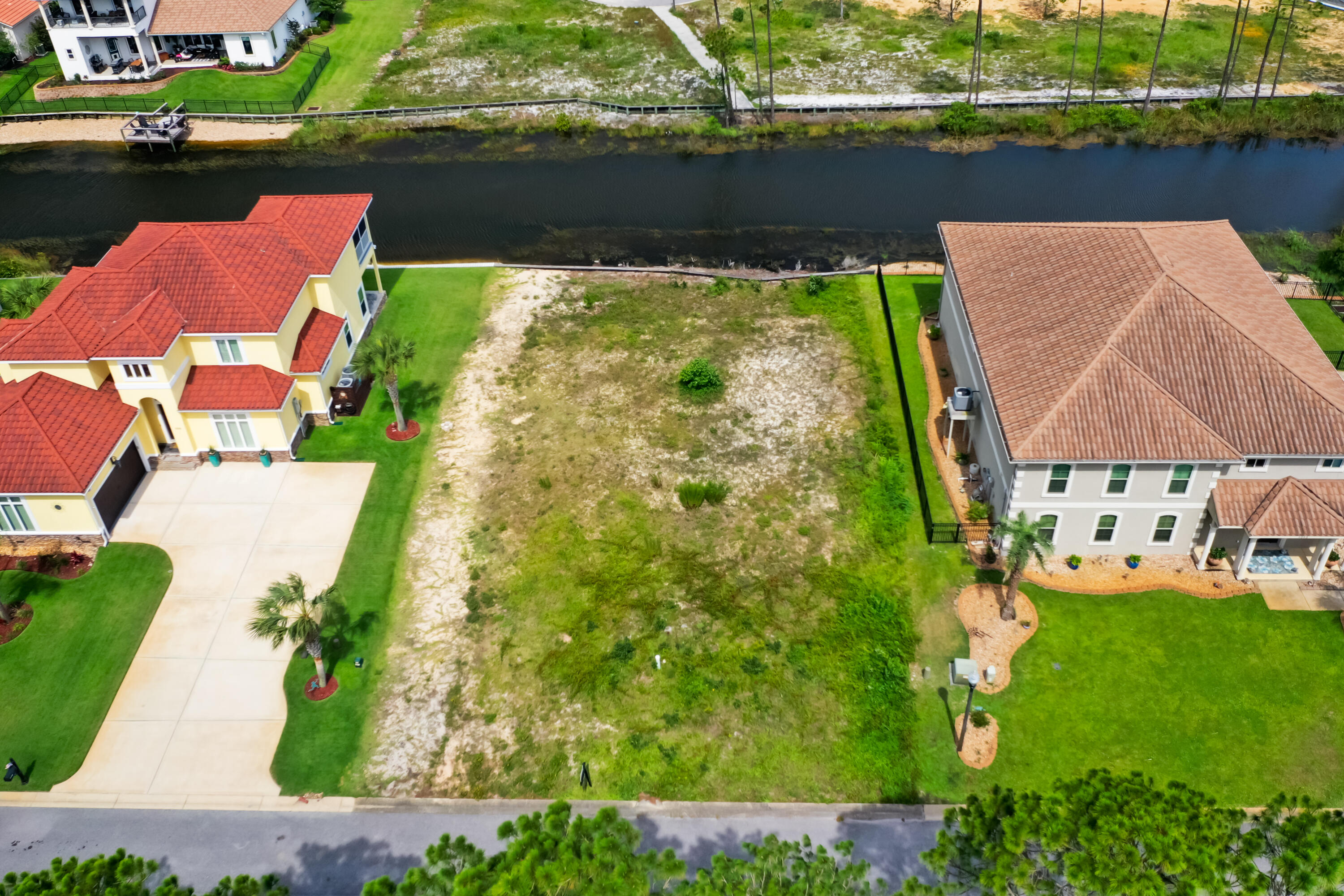 9389 Palmetto Ridge Court Navarre, FL 32566 - Photo 2 of 33 an aerial view of a house with a garden and lake view