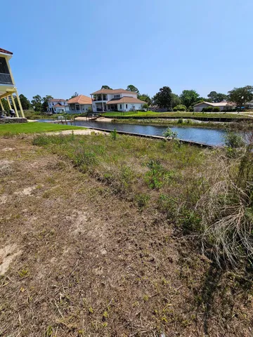 a view of a lake with houses in the back