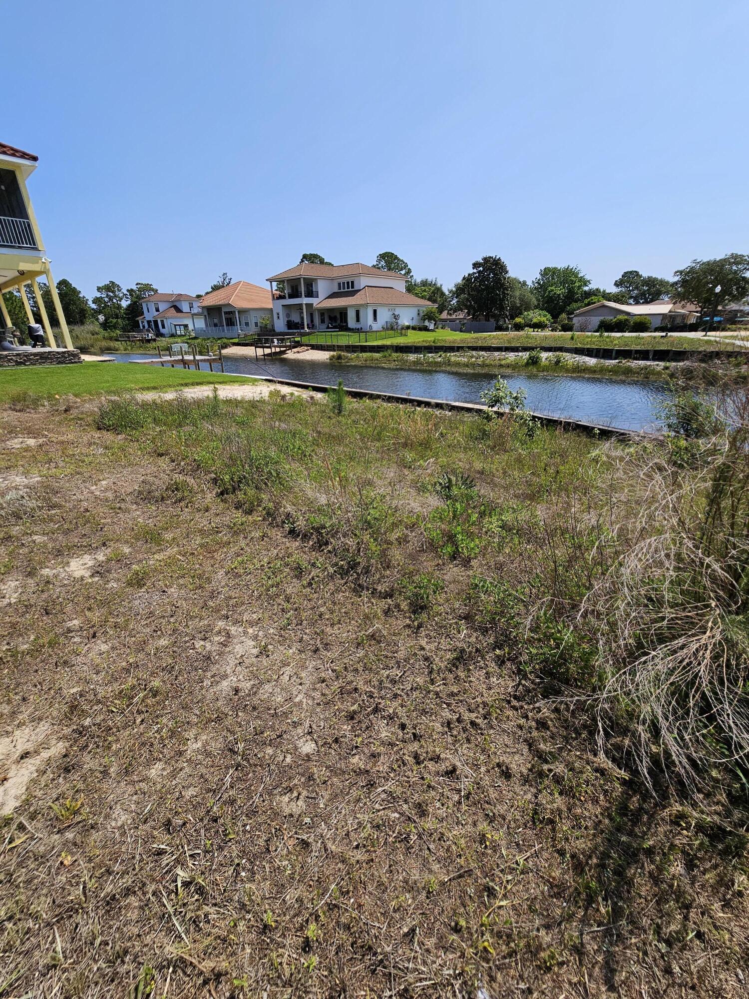 9389 Palmetto Ridge Court Navarre, FL 32566 - Photo 28 of 33 a view of a lake with houses in the back