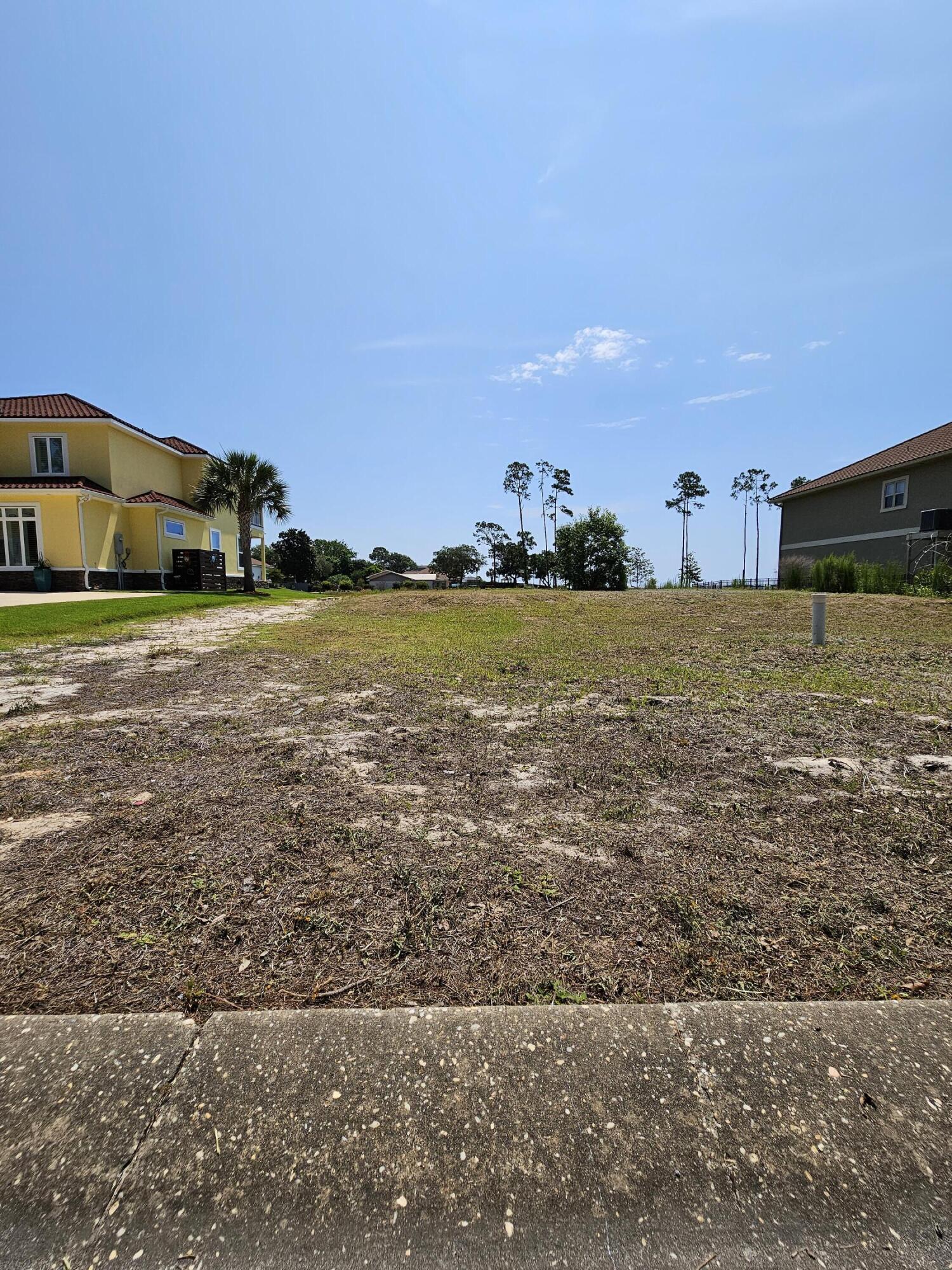 9389 Palmetto Ridge Court Navarre, FL 32566 - Photo 31 of 33 a front view of a house with a yard