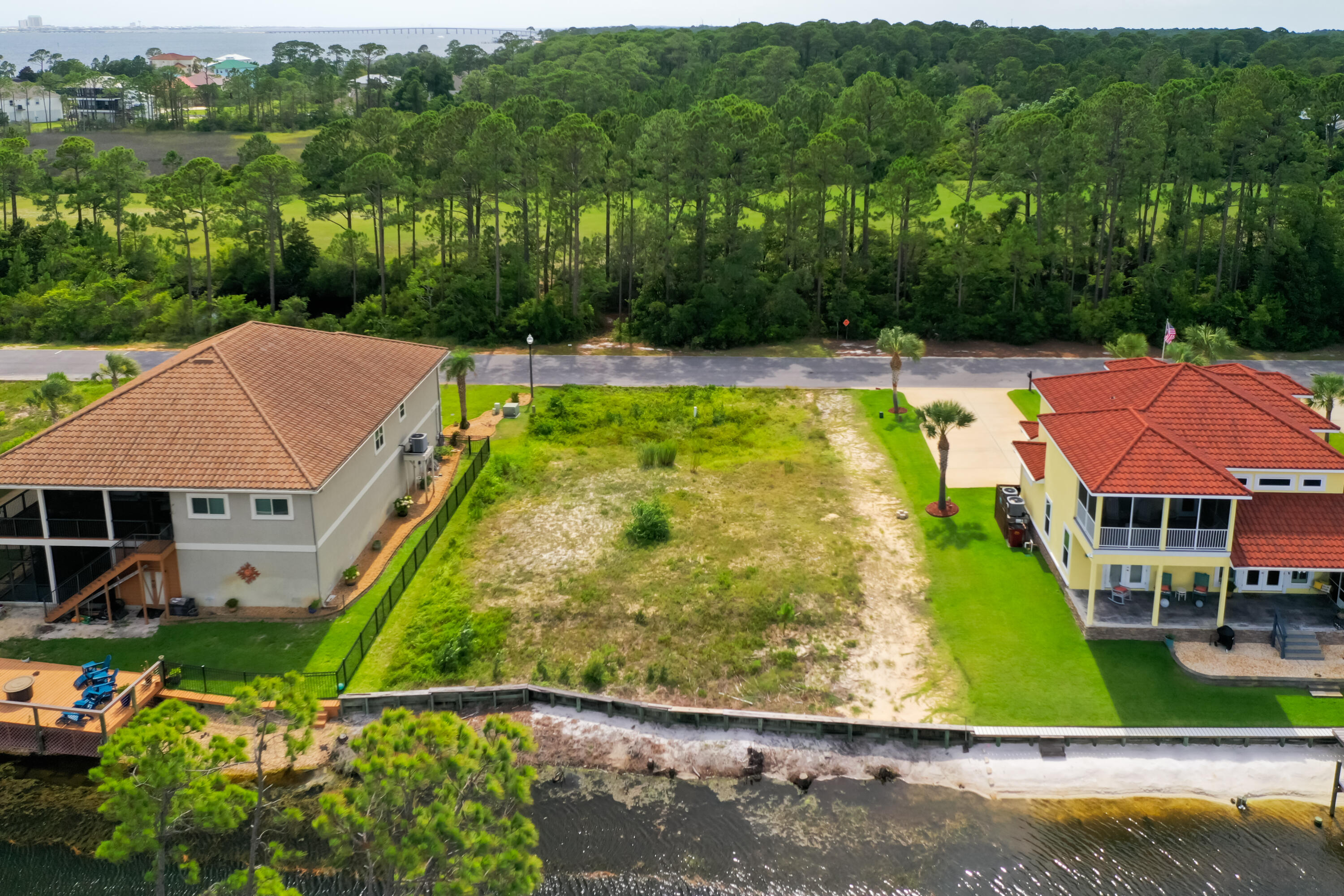 9389 Palmetto Ridge Court Navarre, FL 32566 - Photo 6 of 33 a view of a swimming pool with a garden