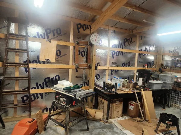 a view of a living room with a table and chairs