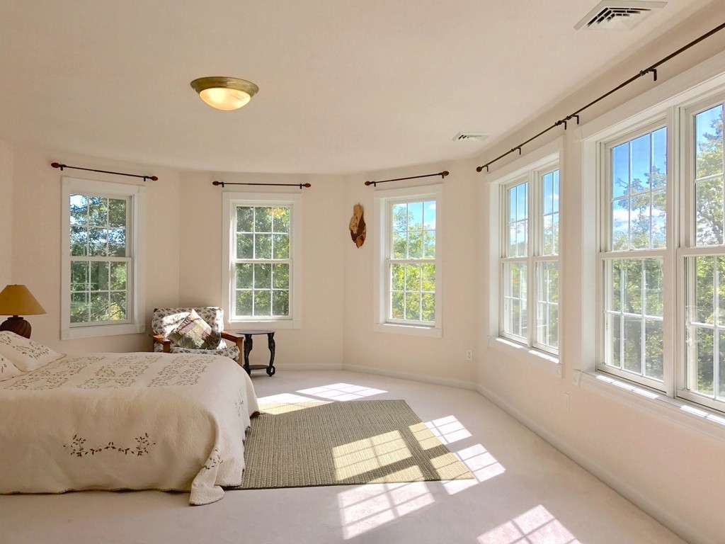 160 East Leverett Road Amherst, MA 01002 - Photo 20 of 30 a spacious bedroom with a bed and a large window