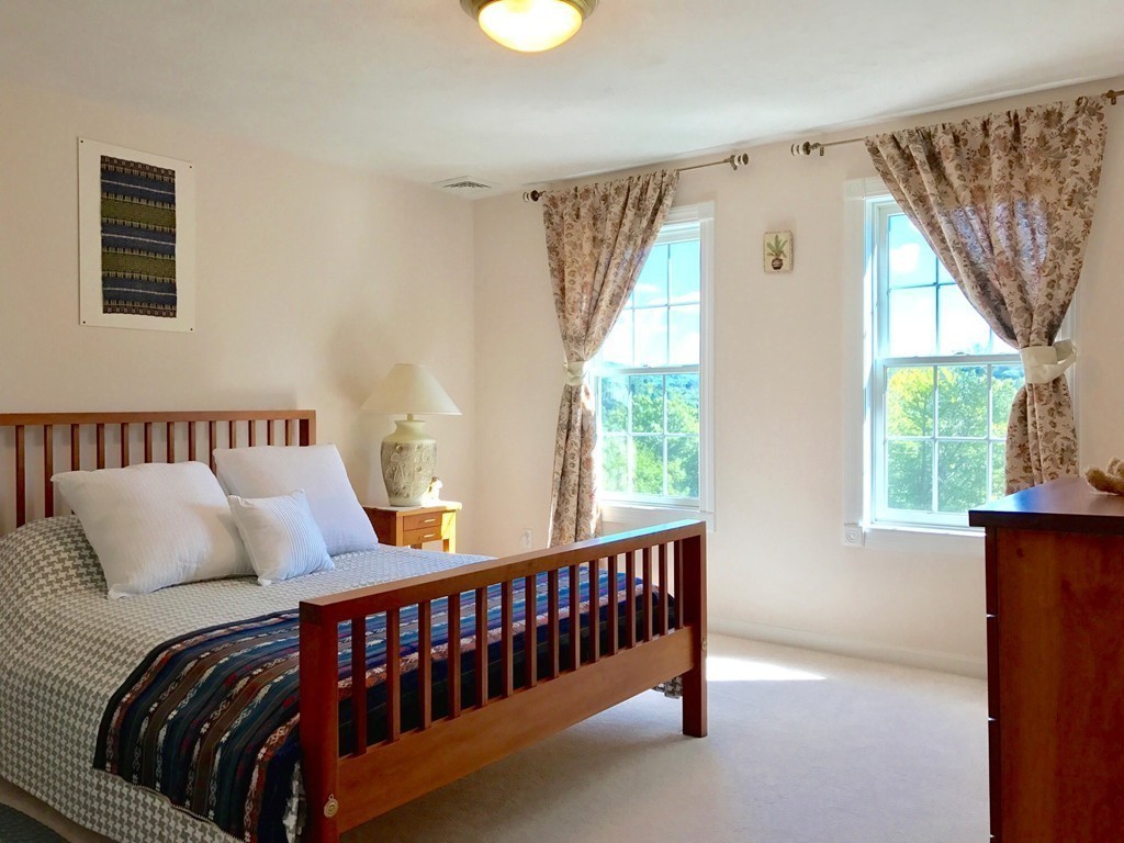 160 East Leverett Road Amherst, MA 01002 - Photo 24 of 30 a bed sitting in a bedroom next to a window
