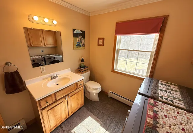 a bathroom with a sink a toilet and mirror