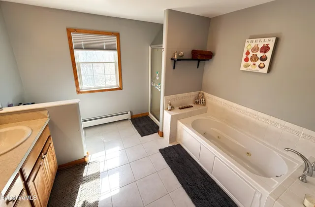 a spacious bathroom with a bathtub and a shower