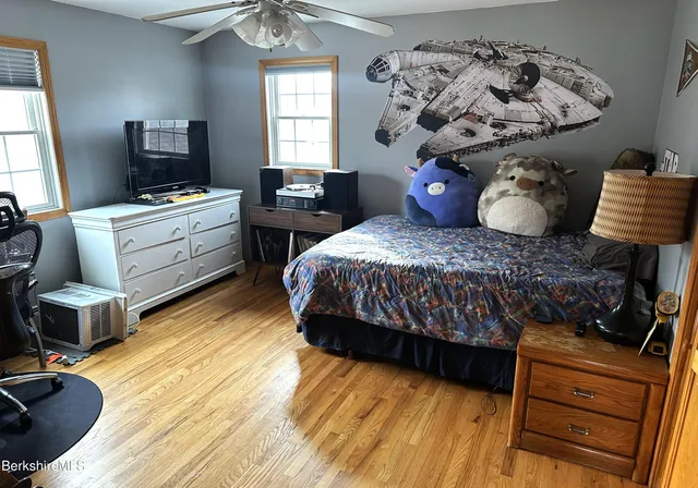 a bedroom with a bed and wooden floor