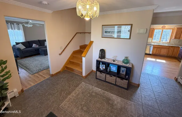 a living room with furniture and a chandelier