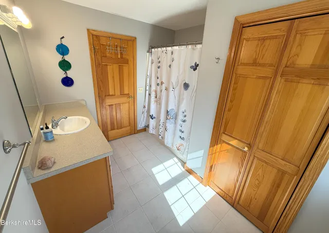 a bathroom with a tub sink and a shower curtain
