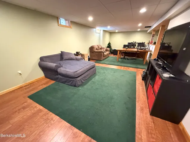 a living room with furniture pool and a flat screen tv