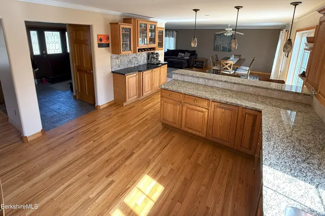 a large kitchen with a wooden floor and a sink