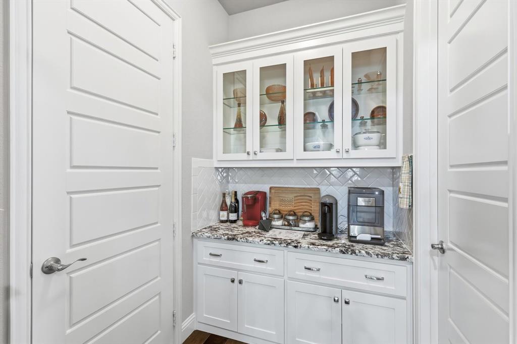 529 Prairie Run Aledo, TX 76008 - Photo 15 of 40 a kitchen with white cabinets and a wooden floor