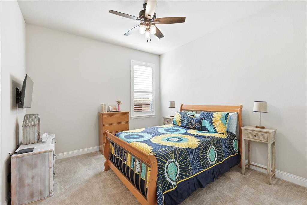 529 Prairie Run Aledo, TX 76008 - Photo 25 of 40 a bedroom with a bed and a chandelier