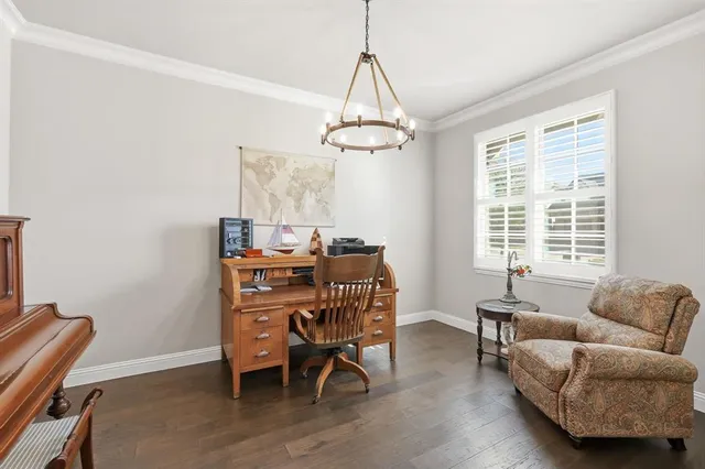 a livingroom with workspace and a window