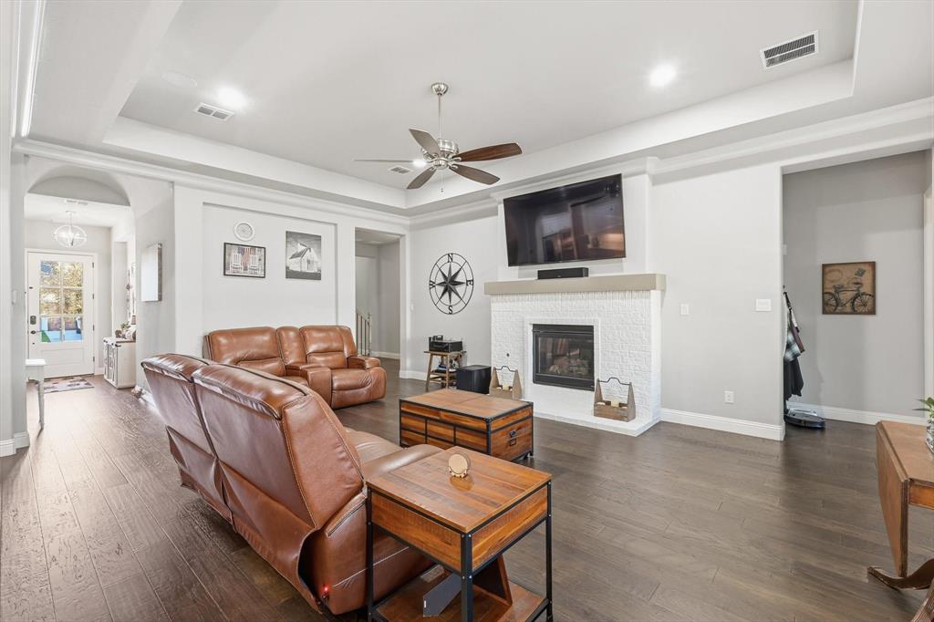 529 Prairie Run Aledo, TX 76008 - Photo 10 of 40 a living room with furniture a fireplace and a flat screen tv