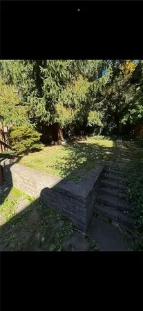 a view of a livingroom with furniture and staircase