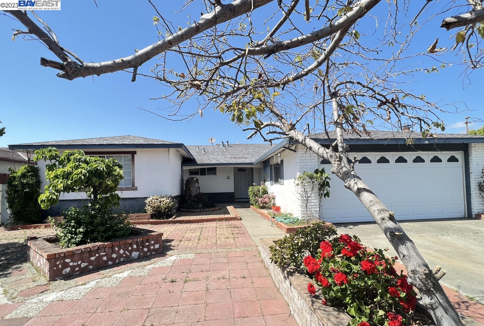 a front view of a house with flowers