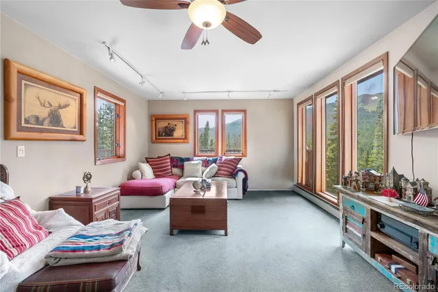 a bedroom with furniture and a large window