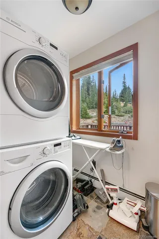 a utility room with sink dryer and washer