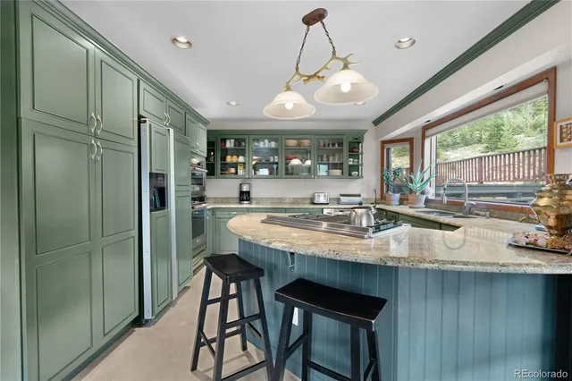a kitchen with stainless steel appliances granite countertop counter space and a large window