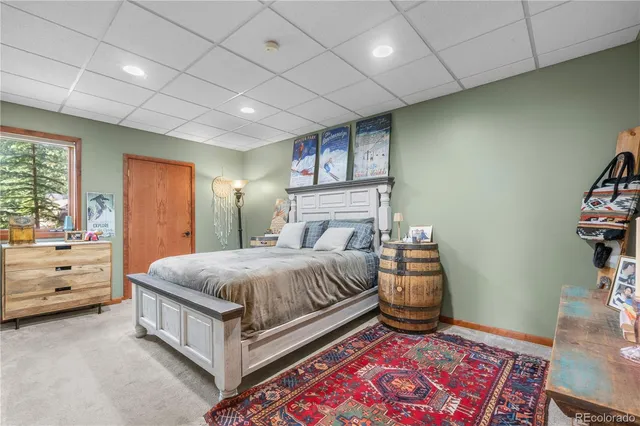 a spacious bedroom with a bed and a dresser