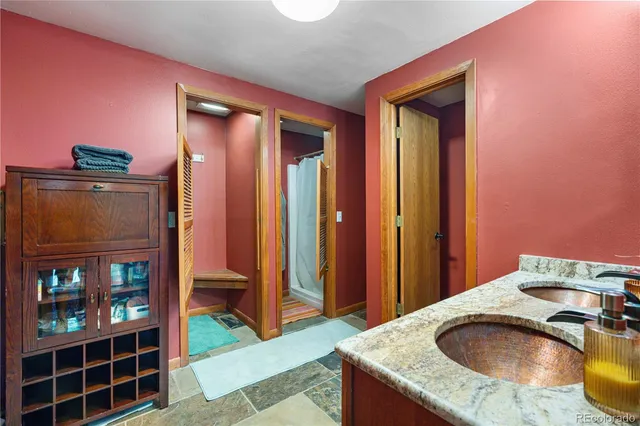 a bathroom with a granite countertop sink and a mirror