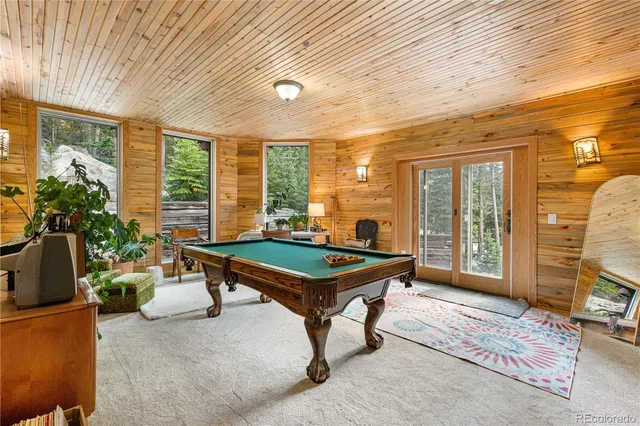 a room with furniture and pool table