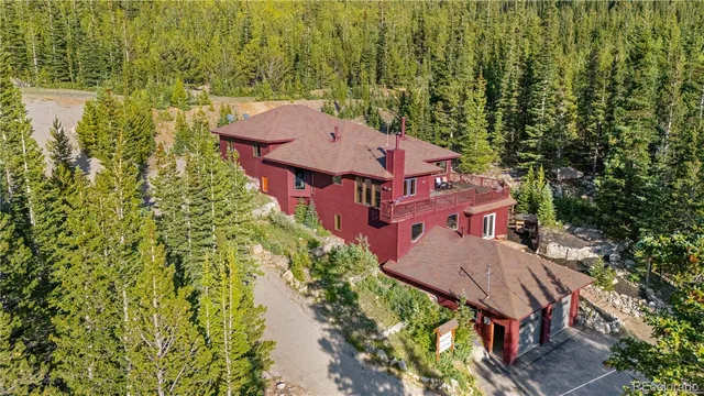 an aerial view of a house with a yard basket ball court and outdoor seating