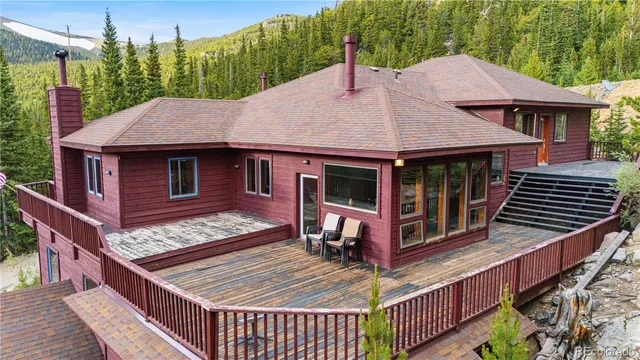a view of a house with wooden deck