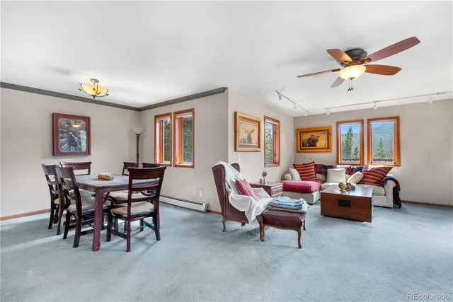 a living room with furniture a chandelier and a window