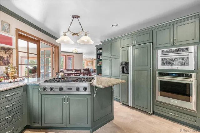 a kitchen with stainless steel appliances granite countertop a stove and a refrigerator