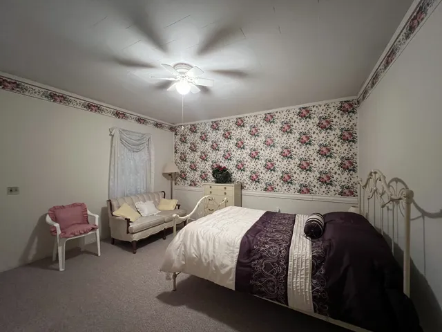 a bed room with a bed and a chair