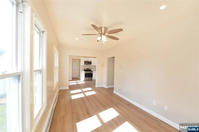 a view of a house with wooden floor and a ceiling fan