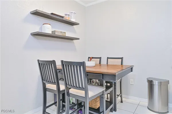 a view of a room that has a table and chairs in it