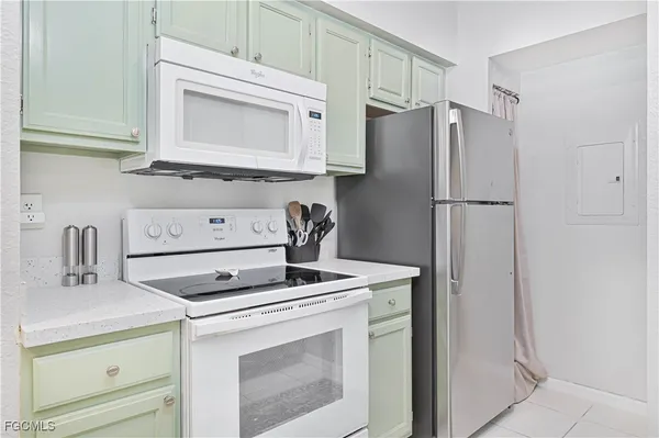 a kitchen with refrigerator a stove a sink and cabinets