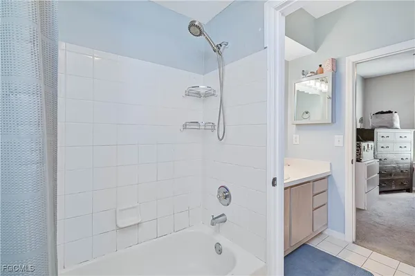 a bathroom with a bathtub a sink a vanity and a shower