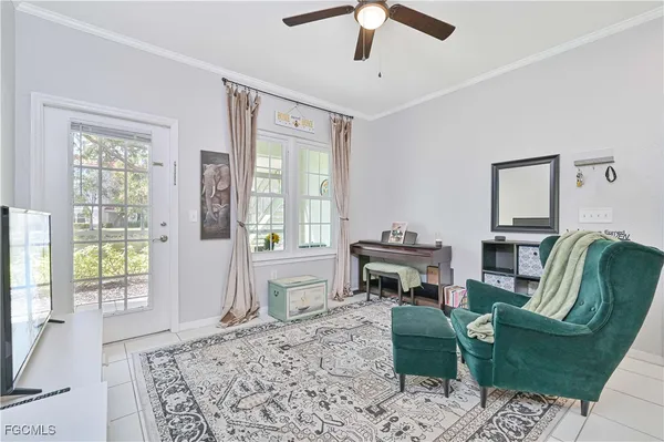 a living room with furniture a flat screen tv and a large window