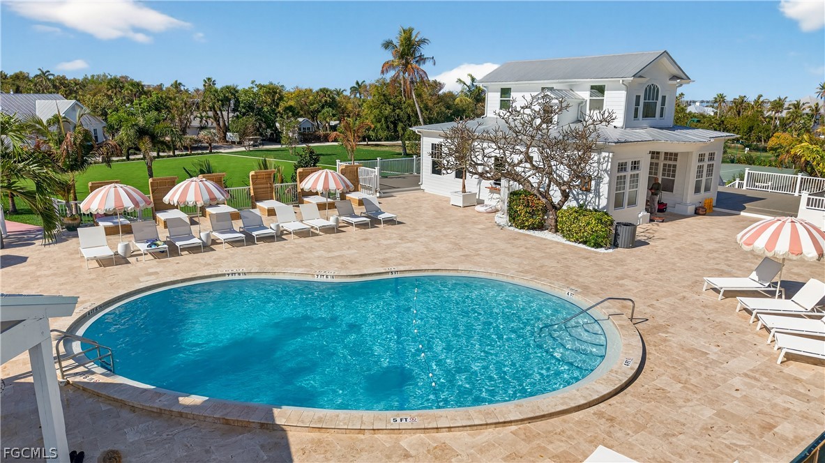 440 Useppa Island Bokeelia, FL 33922 - Photo 17 of 25 a view of a swimming pool with a patio and a garden