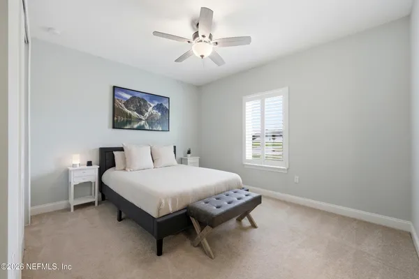 a dining room with furniture and a floor to ceiling window