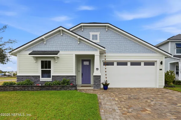 a living room with furniture and a view of kitchen