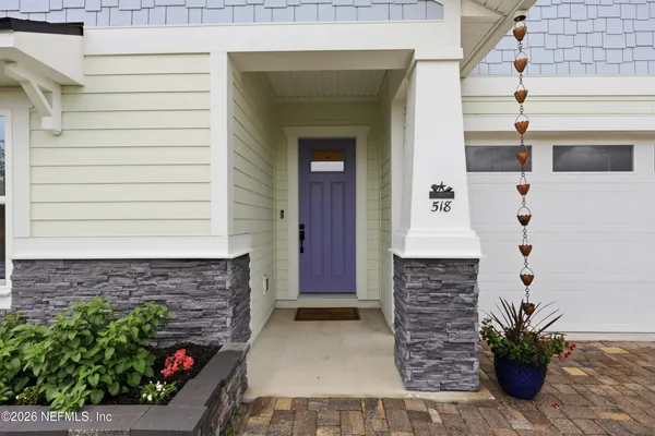 a living room with furniture a flat screen tv and a large window